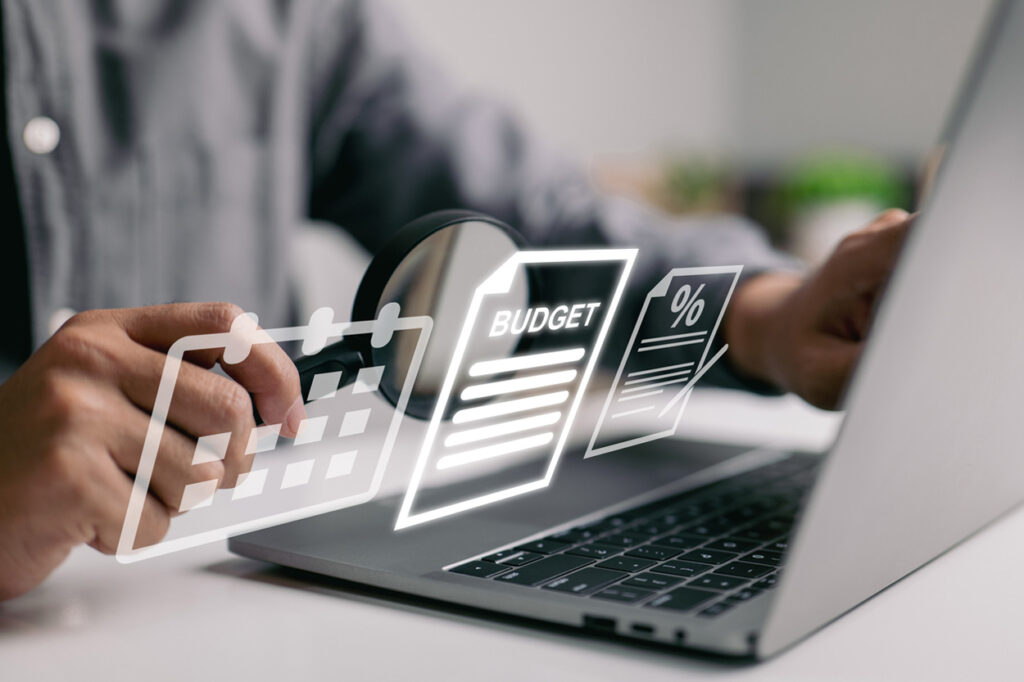 Travel management with budget and scheduling tools on laptop.